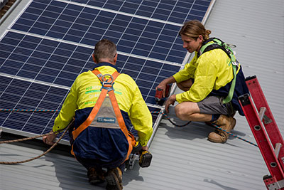 Team installing solar panels